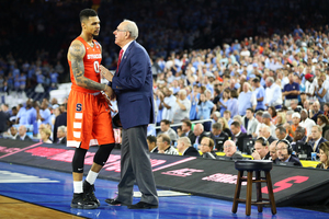Jim Boeheim talks to senior Michael Gbinije before the point guard goes to the bench. Boeheim talked about this season and next, while this was Gbinije's last. 