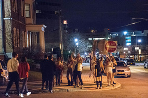 Students walk around the Syracuse University campus in search for the next party to attend.
