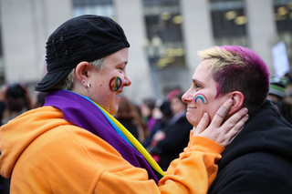 A couple look into each other's eyes before sharing a kiss during the Washington D.C. march.